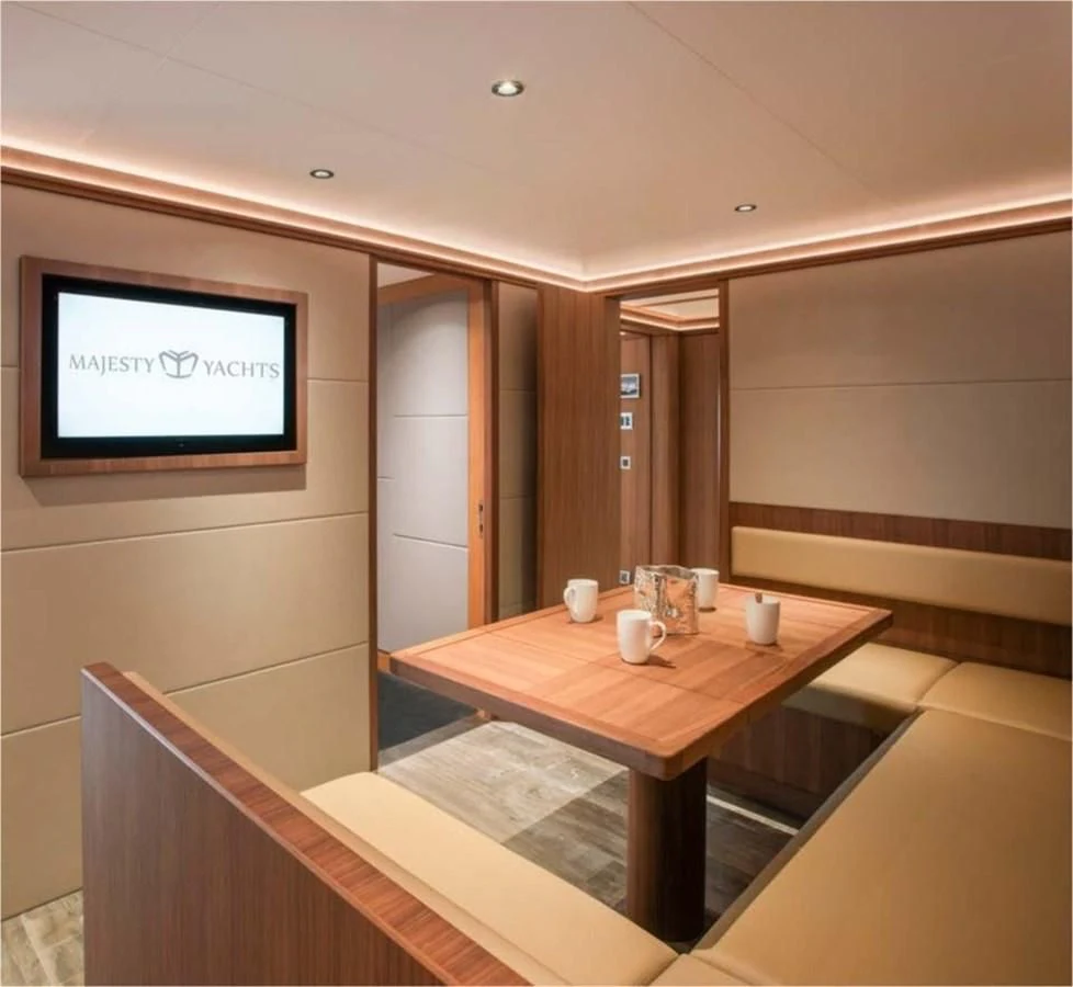 a table with a tv on it aboard MAJESTY 155 Yacht for Sale
