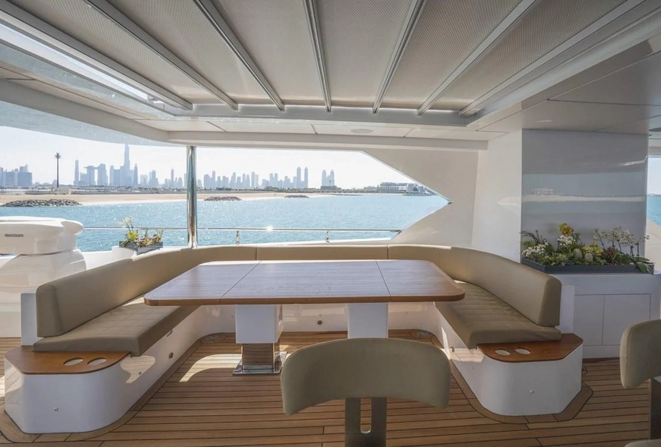 a room with a table and chairs aboard MAJESTY 155 Yacht for Sale