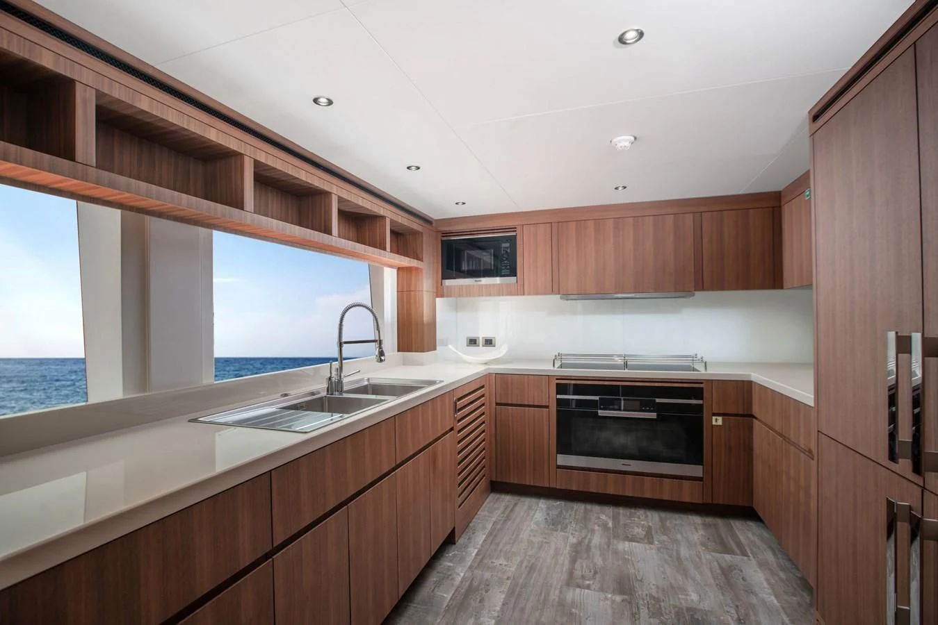 a kitchen with wooden cabinets aboard MAJESTY 155 Yacht for Sale