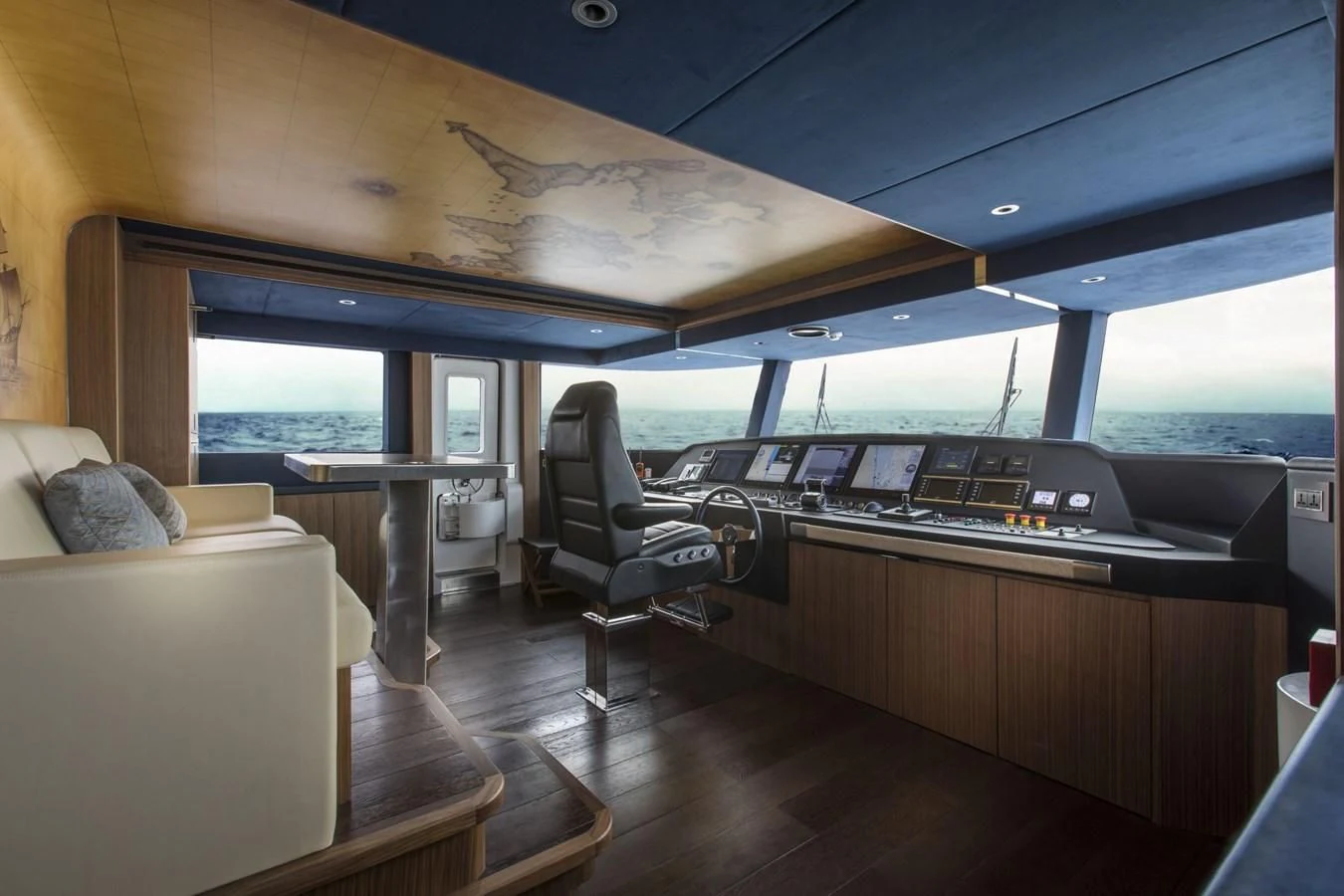 a room with a large window and a table with chairs and a couch aboard MAJESTY 155 Yacht for Sale