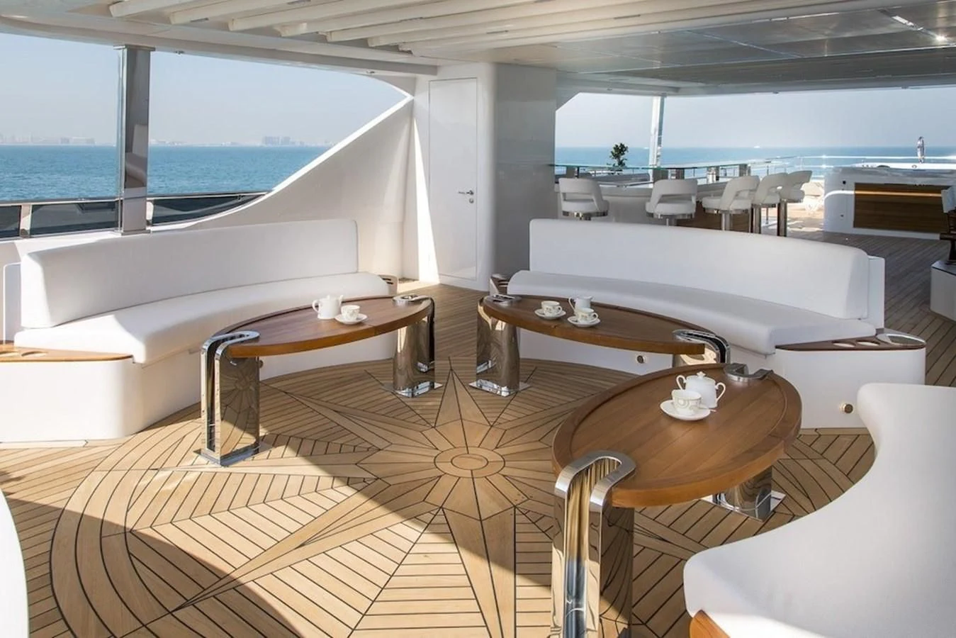 a room with tables and chairs aboard MAJESTY 155 Yacht for Sale