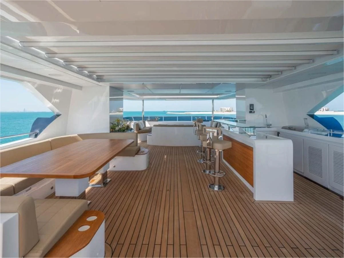 a room with a wood floor and a large window with a view of the ocean aboard MAJESTY 155 Yacht for Sale