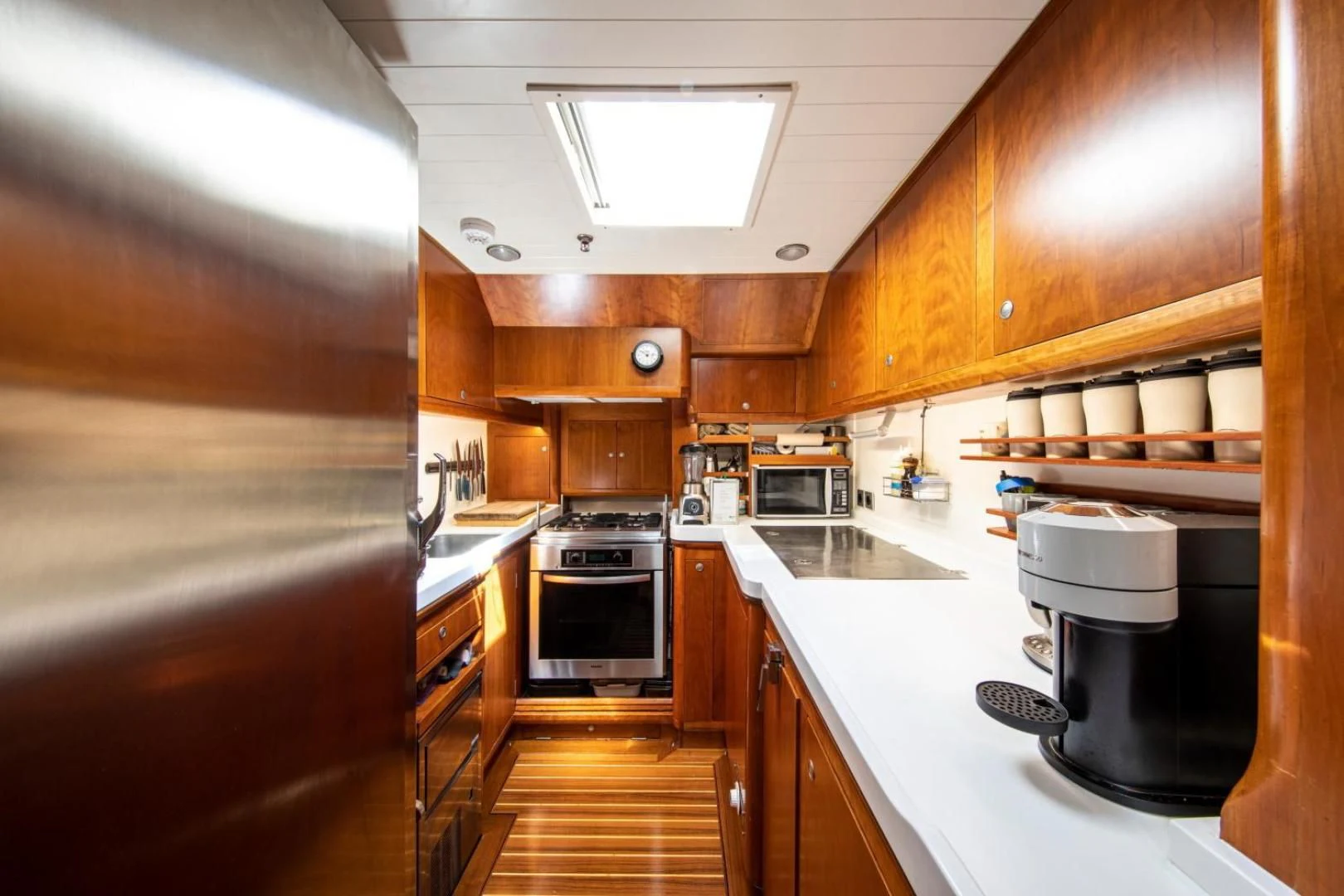 a kitchen with wooden cabinets aboard WAVELENGTH Yacht for Sale