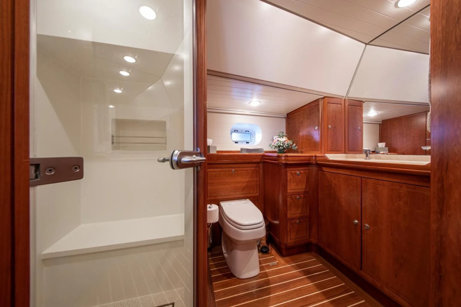 a bathroom with wooden cabinets aboard WAVELENGTH Yacht for Sale