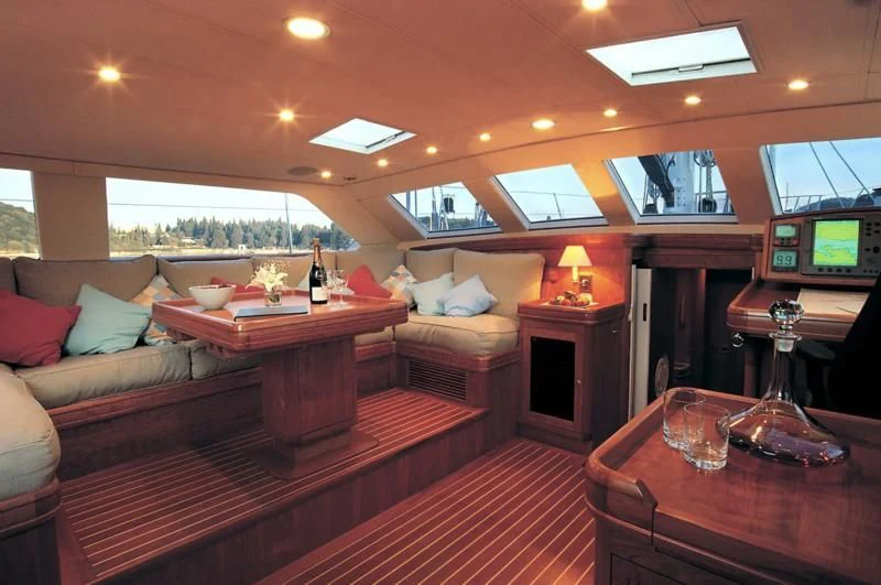 a room with a couch and a table and a television aboard WAVELENGTH Yacht for Sale
