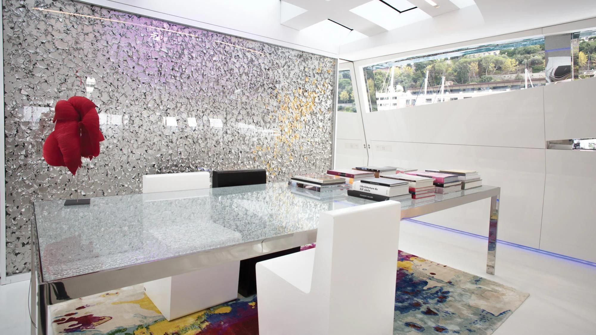 a room with a desk and a large red rose on the wall aboard FLYING DAGGER Yacht for Sale