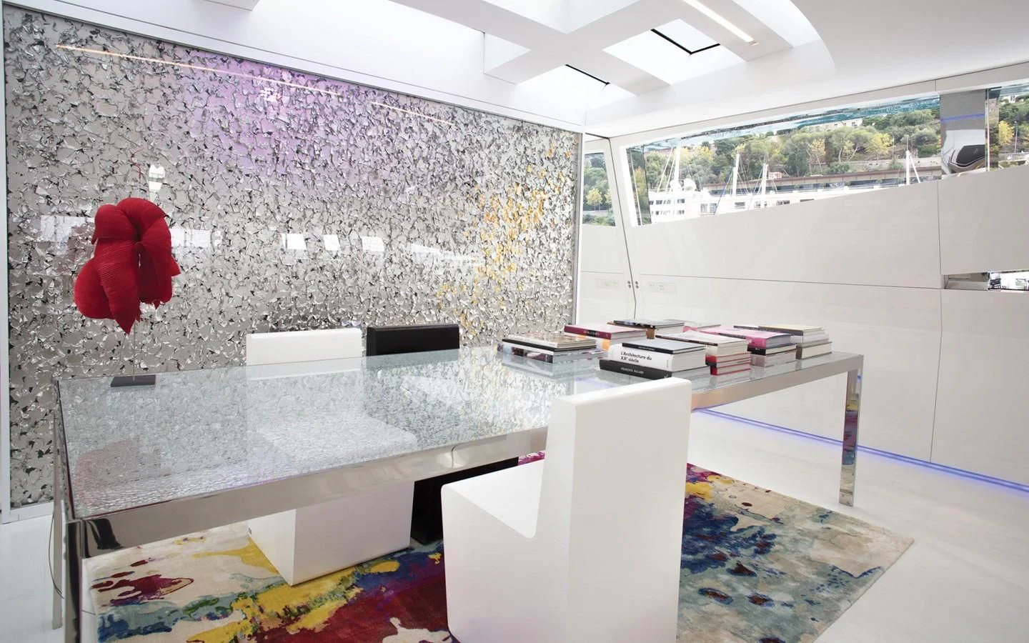 a room with a white table and red flower on the wall aboard FLYING DAGGER Yacht for Sale