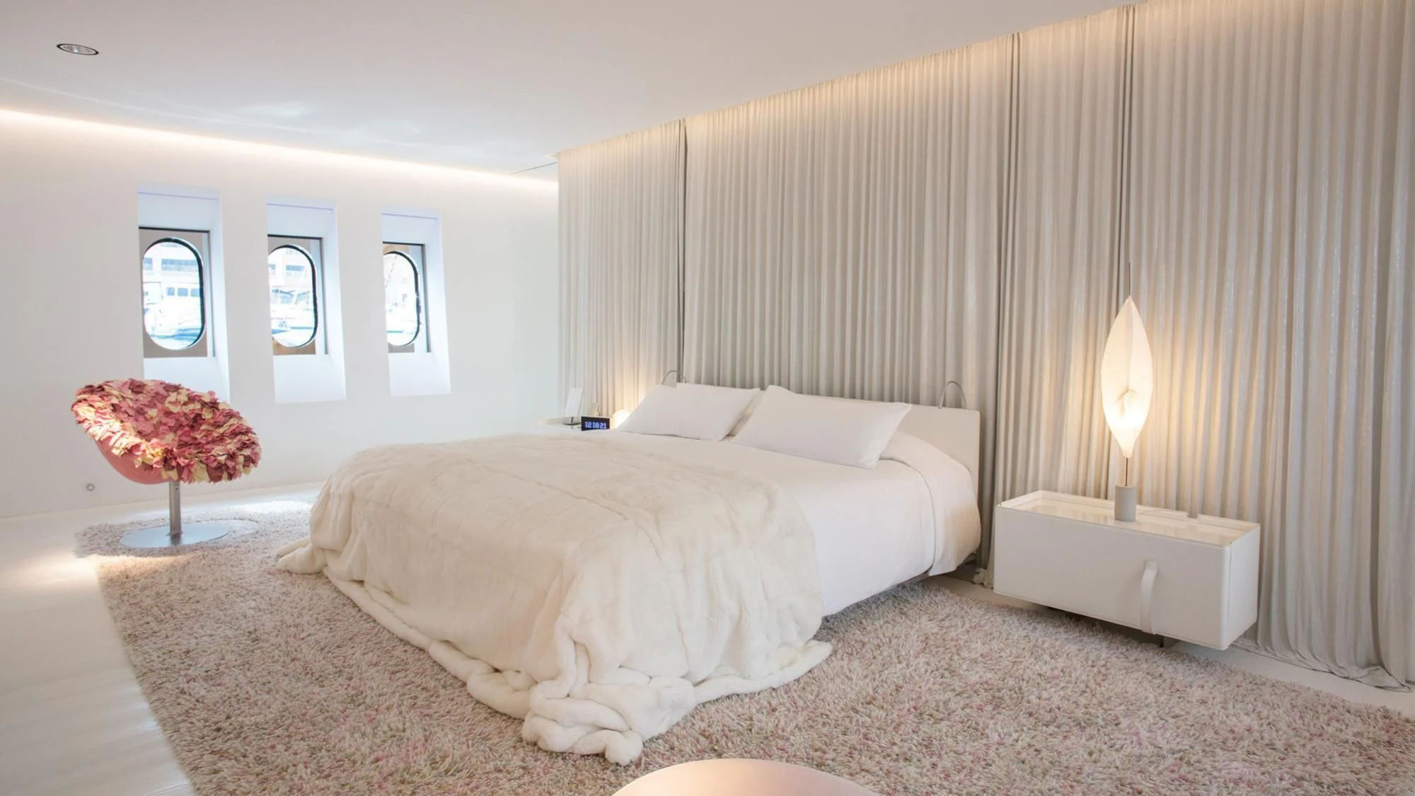 a bedroom with a bed and a lamp aboard FLYING DAGGER Yacht for Sale