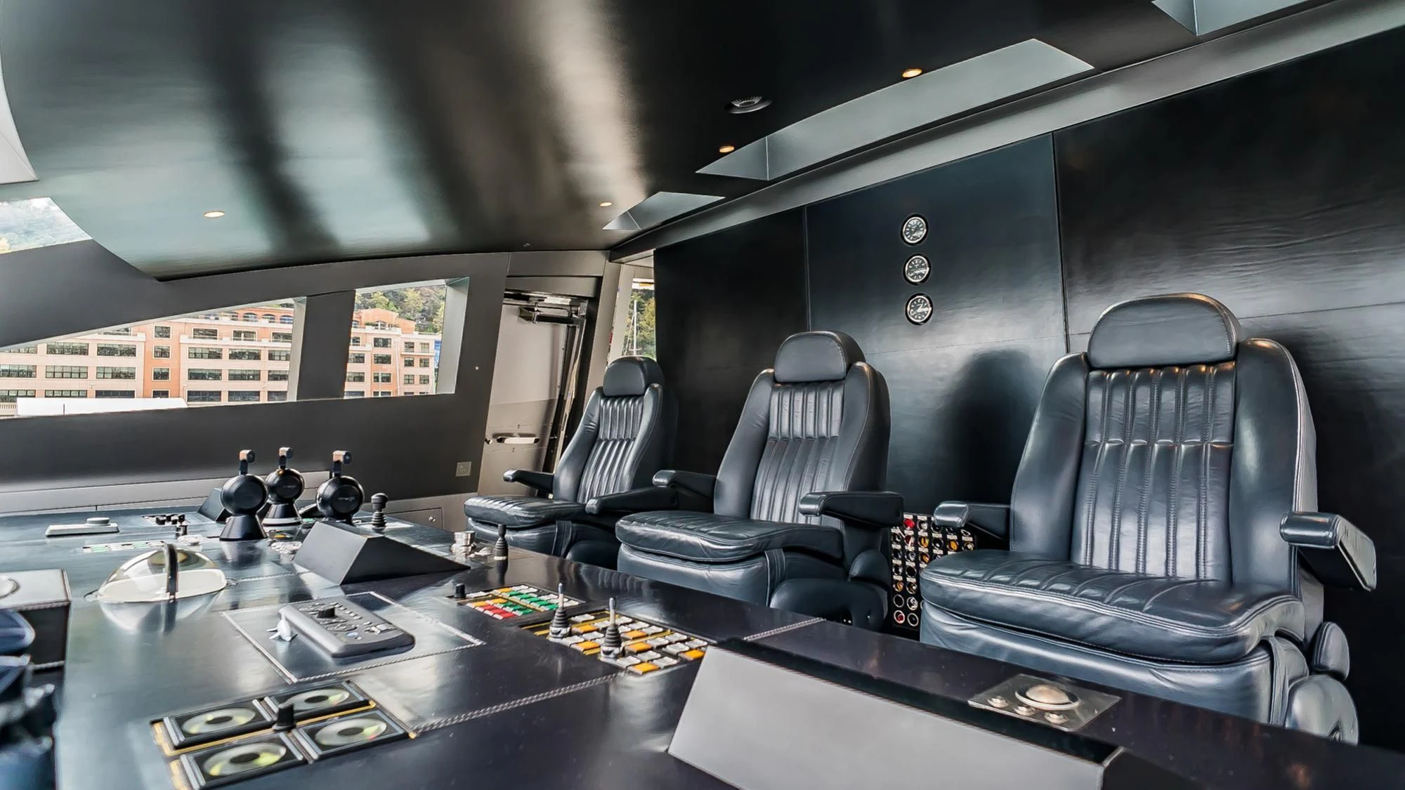 a room with a table chairs and a window with a view of a city aboard FLYING DAGGER Yacht for Sale