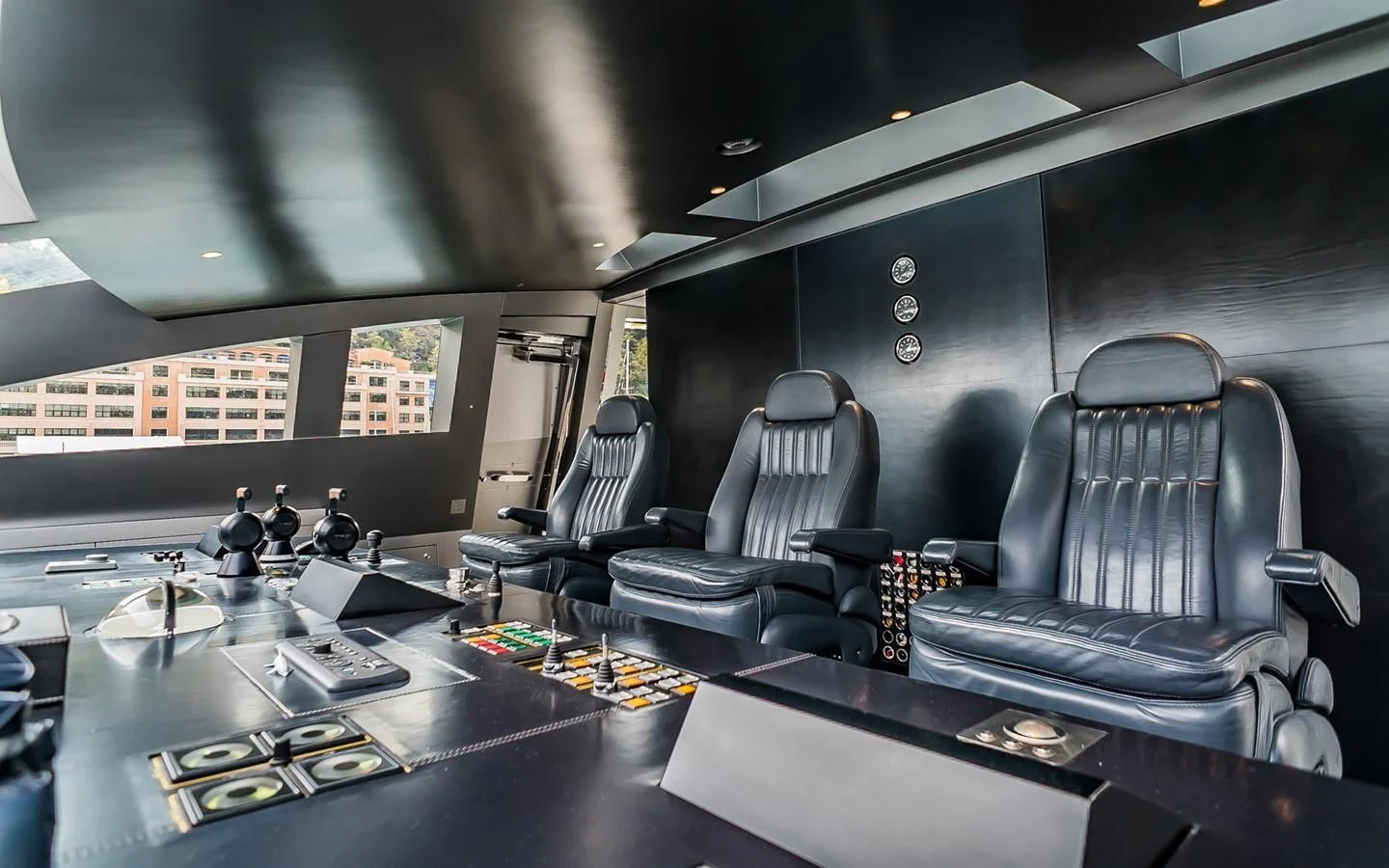a group of people sitting around a table in a room with a window aboard FLYING DAGGER Yacht for Sale