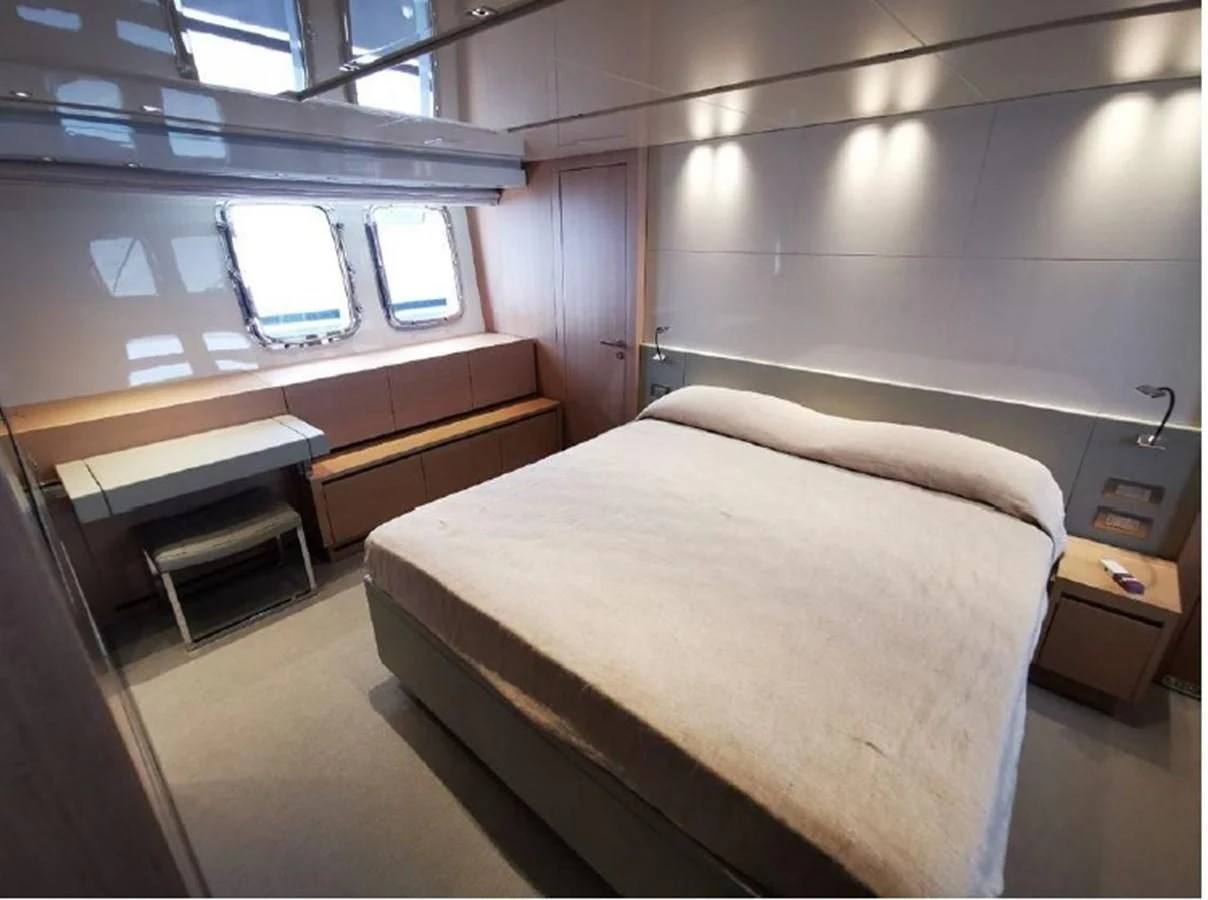 a room with a bed and a desk aboard Y2 Yacht for Sale