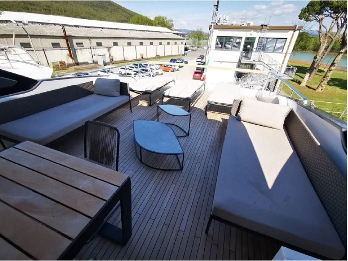 a deck with a table and chairs on it aboard Y2 Yacht for Sale