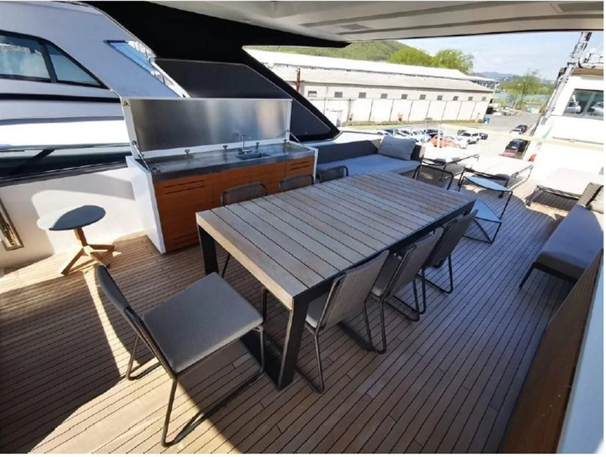 a table and chairs on a deck aboard Y2 Yacht for Sale