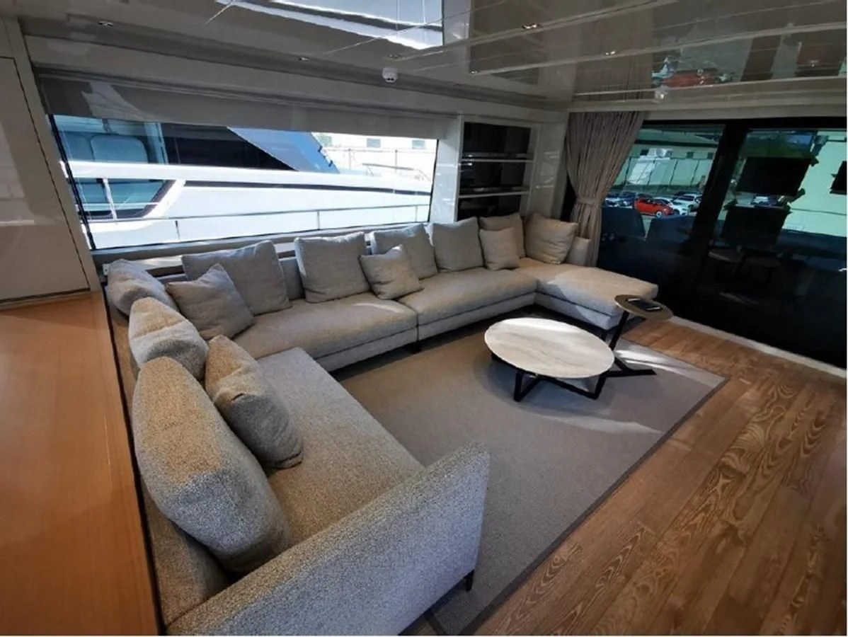 a living room with a couch and a table aboard Y2 Yacht for Sale