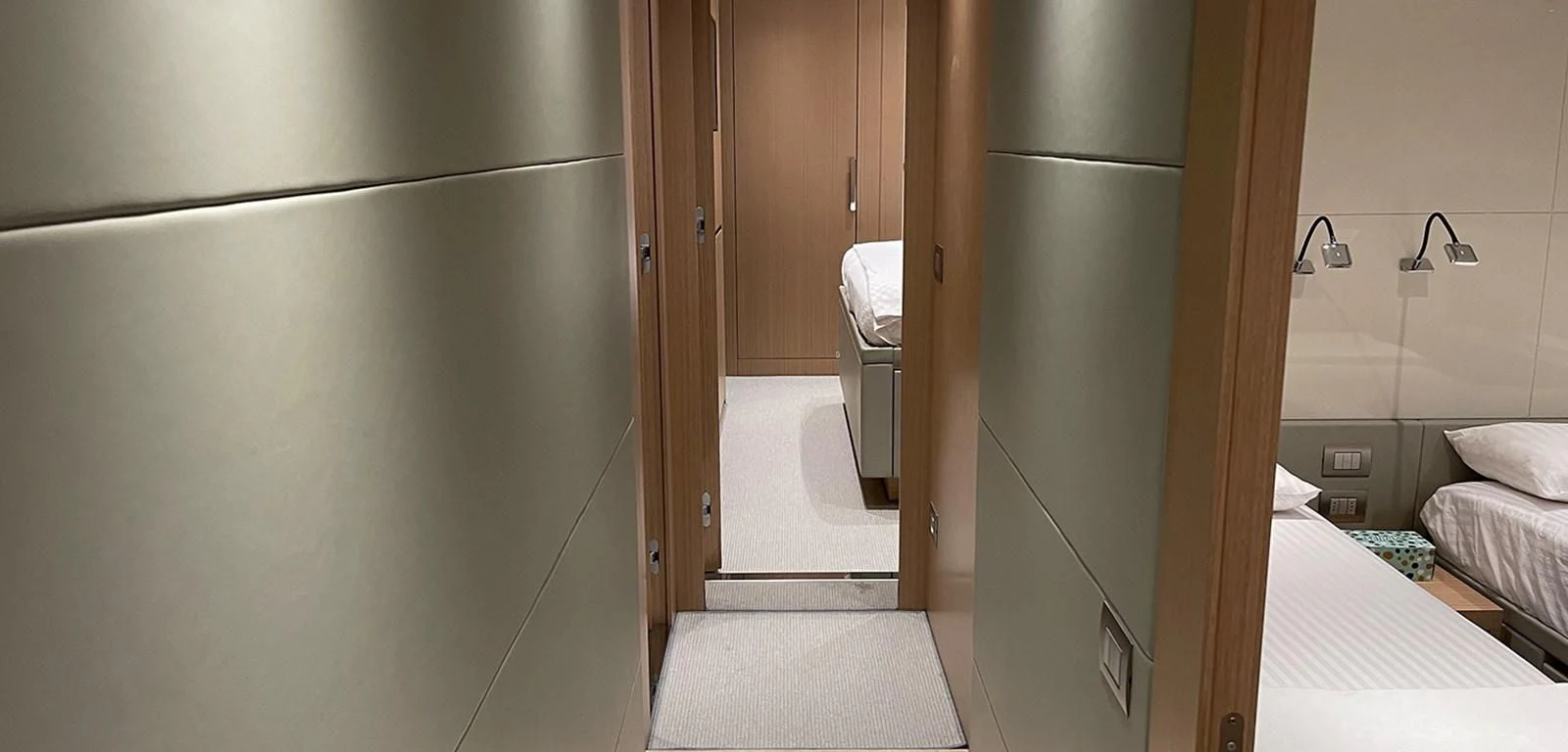 a room with a bed and a refrigerator aboard Y2 Yacht for Sale