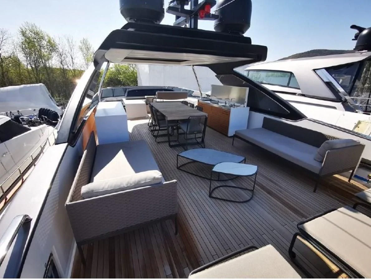 a deck with a table and chairs aboard Y2 Yacht for Sale