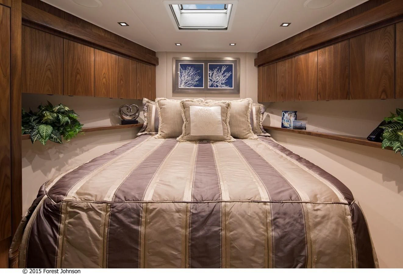 a bed with a brown comforter aboard 80'VIKING 2018 Yacht for Sale