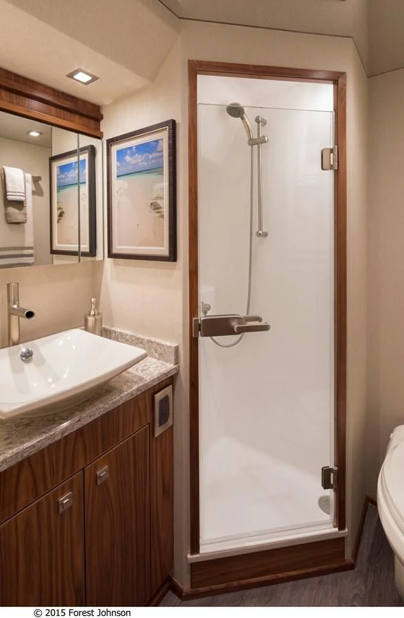a bathroom with a shower and sink aboard 80'VIKING 2018 Yacht for Sale