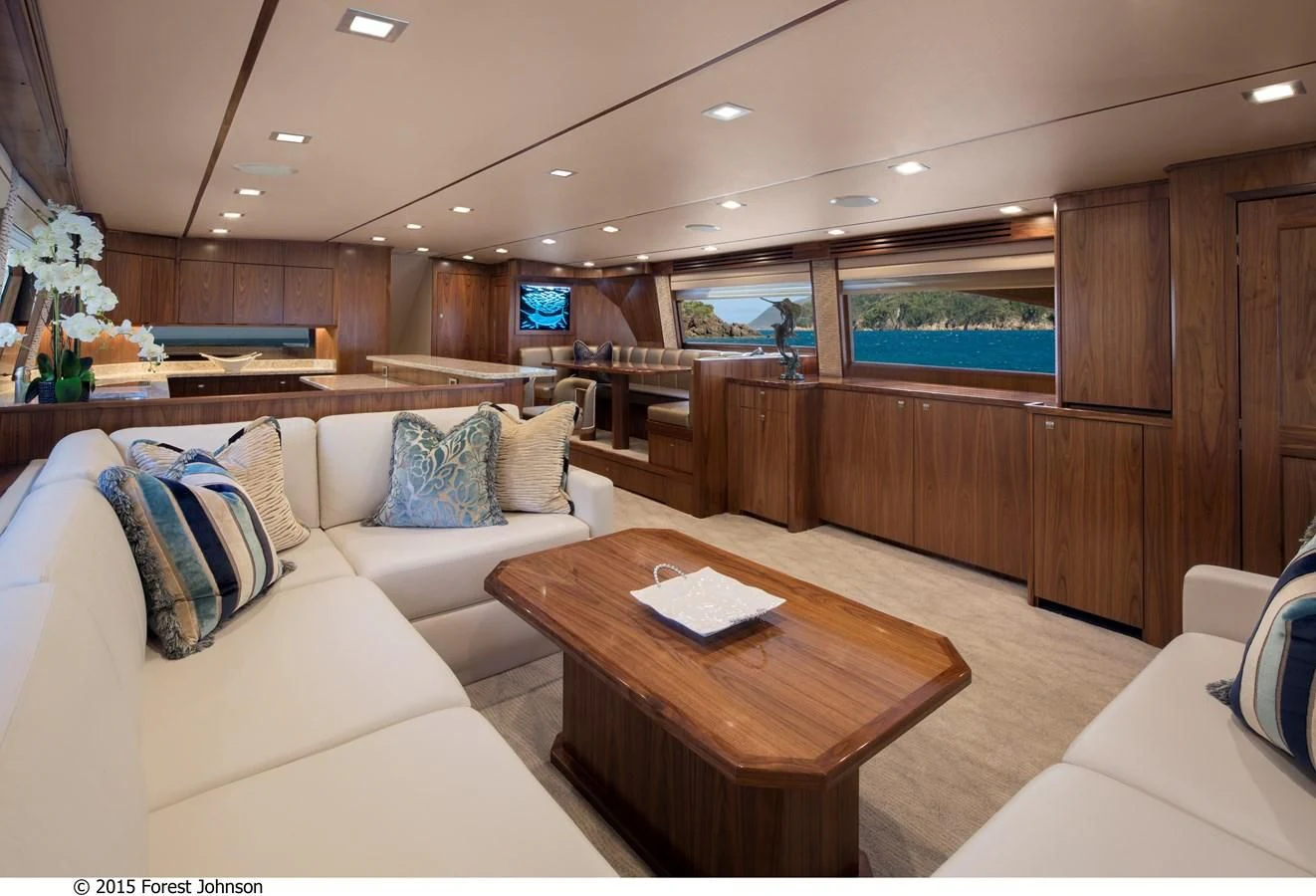 a living room with a couch and a coffee table aboard 80'VIKING 2018 Yacht for Sale