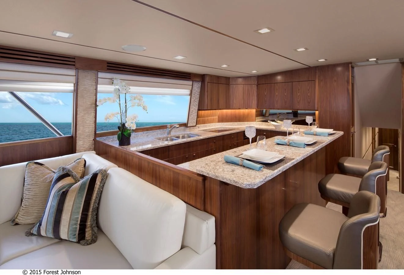 a room with a large table and chairs aboard 80'VIKING 2018 Yacht for Sale