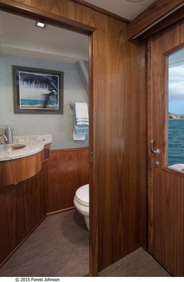 a bathroom with a sink and a toilet aboard 80'VIKING 2018 Yacht for Sale