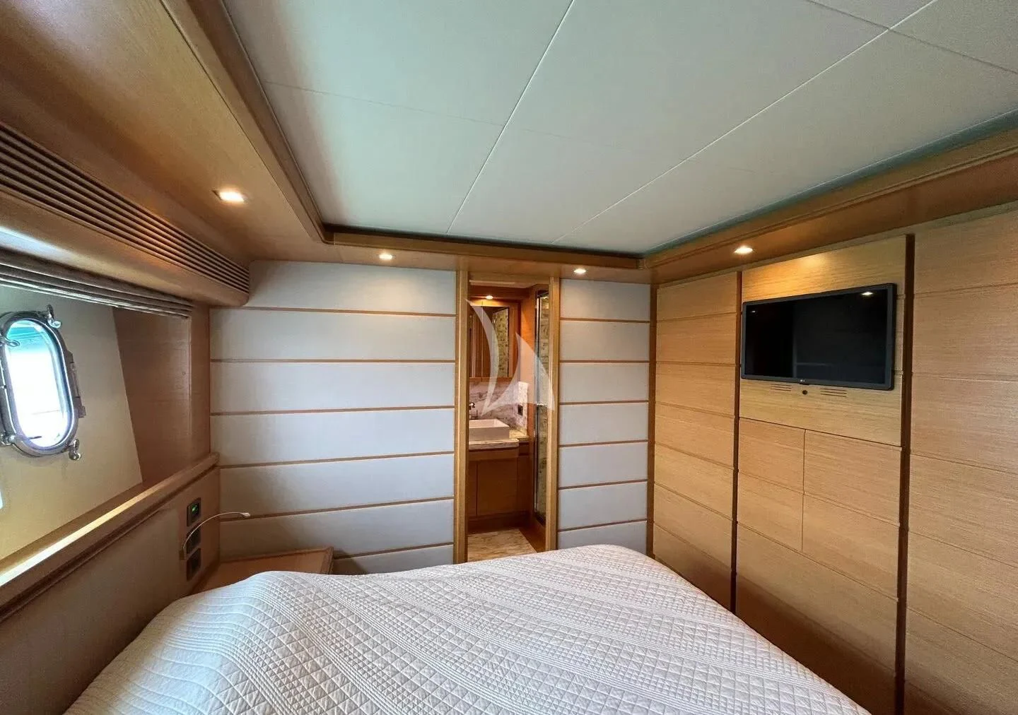 a bedroom with a bed and a television aboard WATCH ME Yacht for Charter