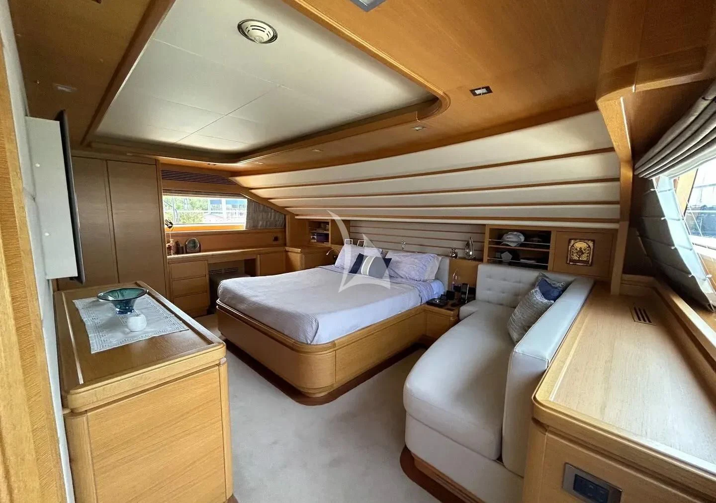 a bedroom with a couch and a television aboard WATCH ME Yacht for Charter