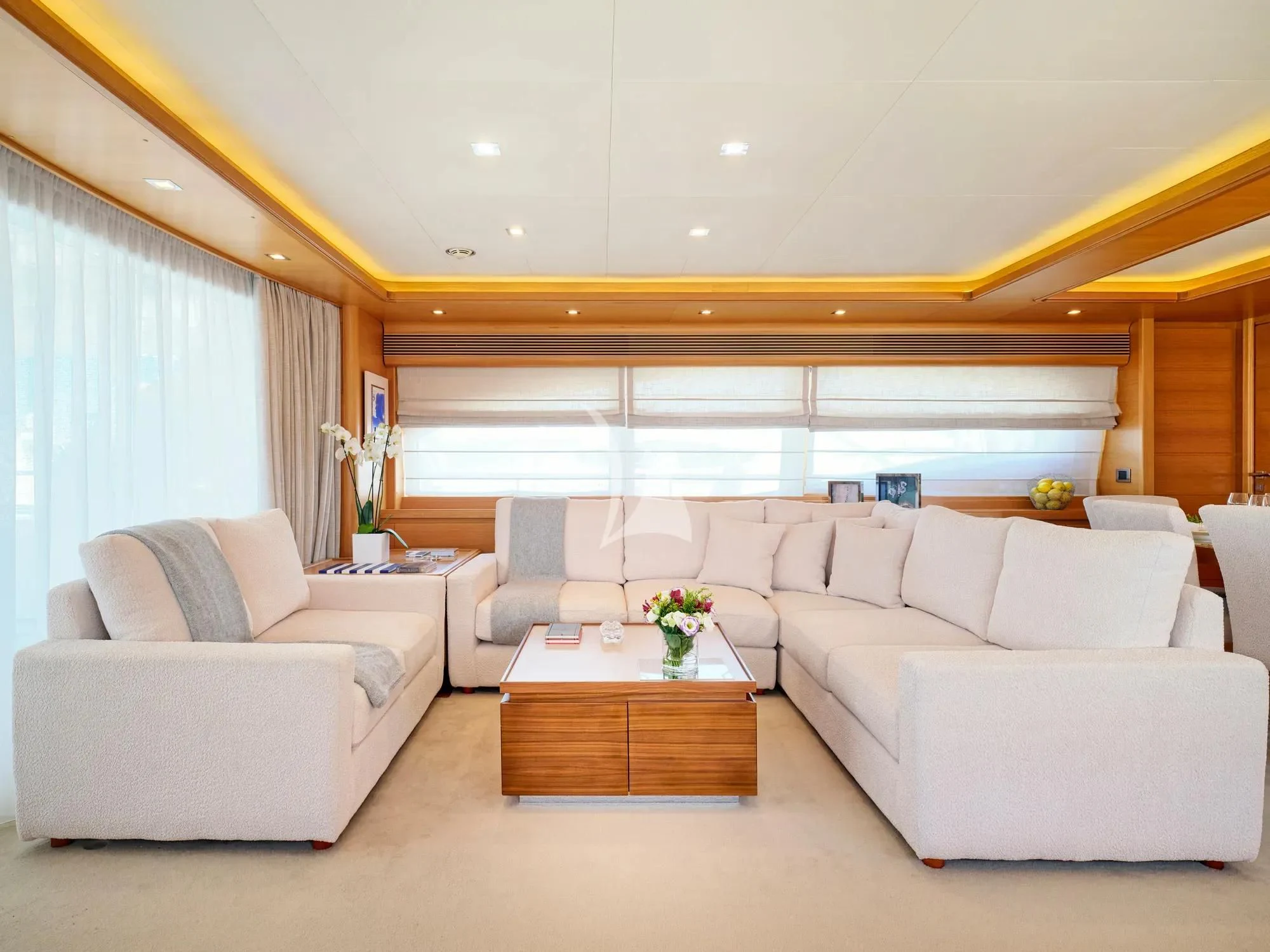a living room with white couches aboard WATCH ME Yacht for Charter