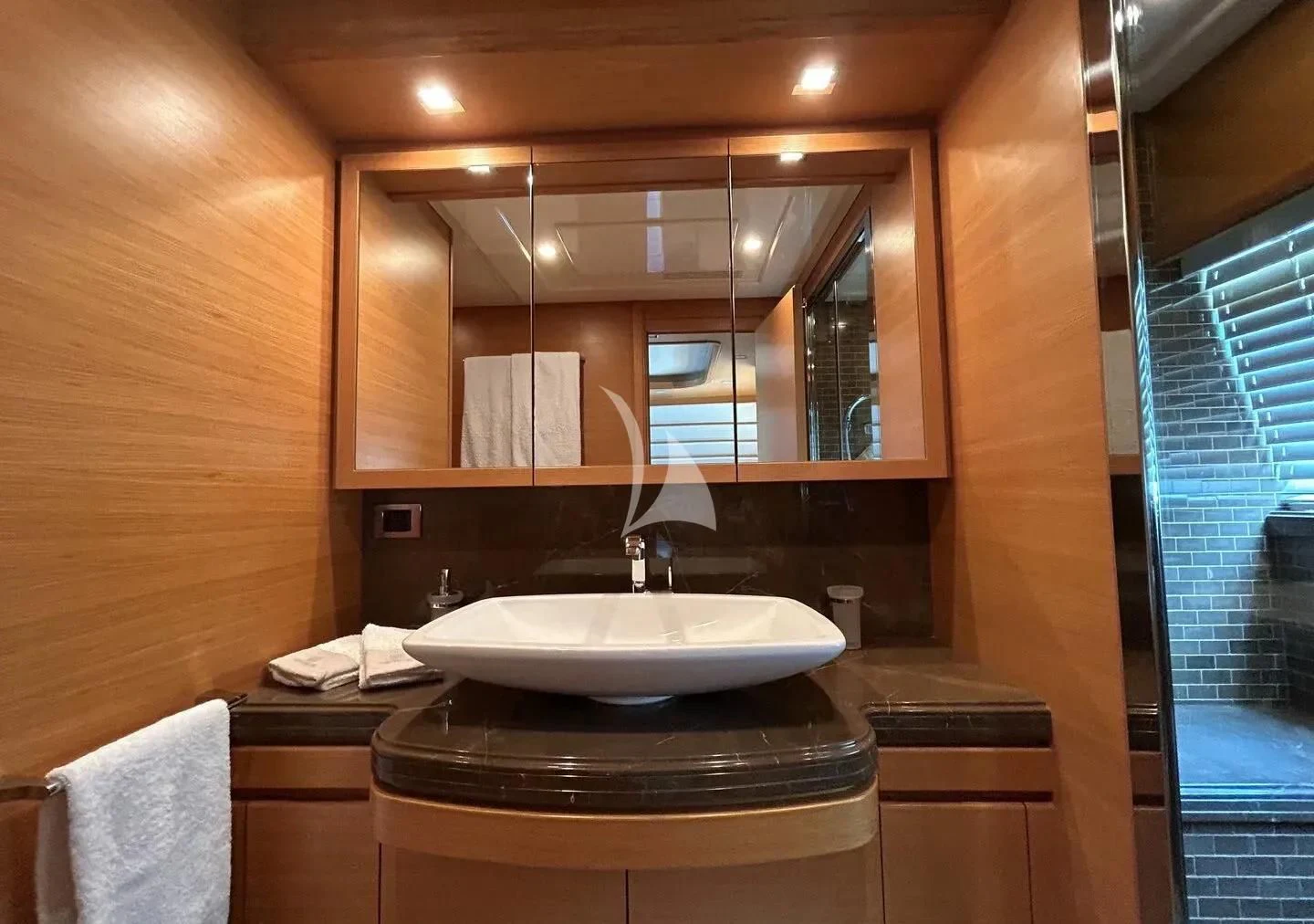 a bathroom with a sink and a mirror aboard WATCH ME Yacht for Charter