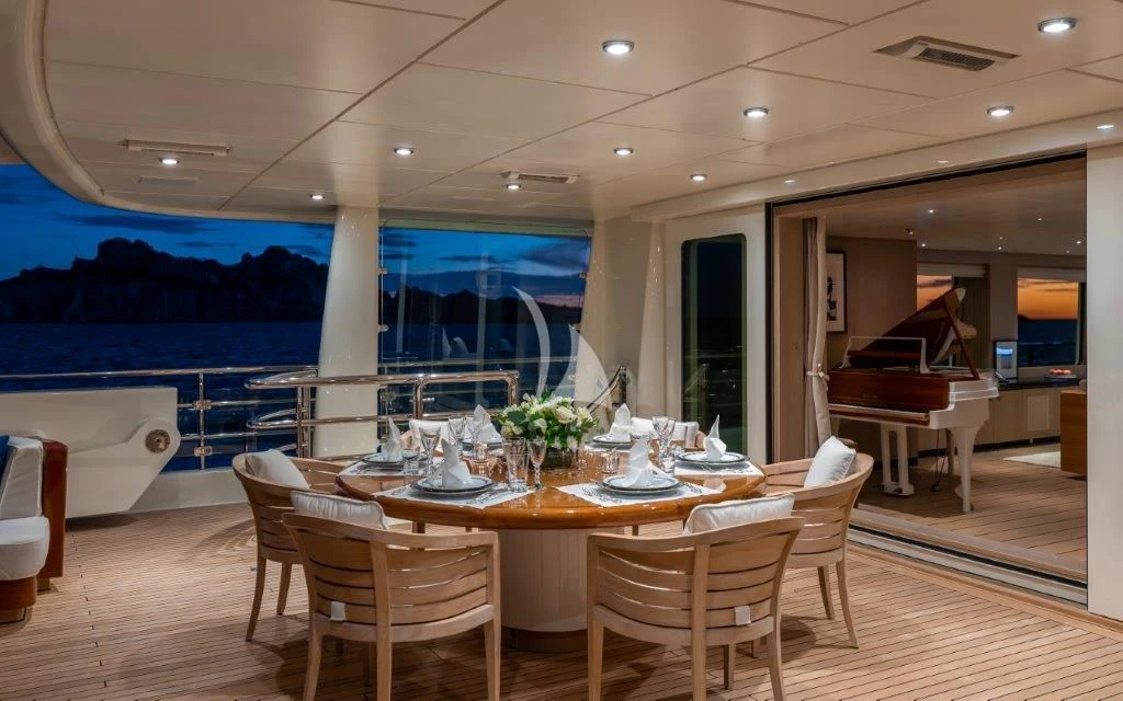 a large room with a table and chairs aboard GRACE (YET) Yacht for Sale