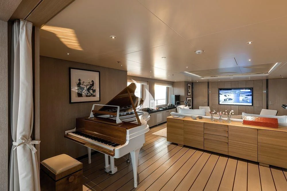 a room with a piano and a piano aboard GRACE (YET) Yacht for Sale