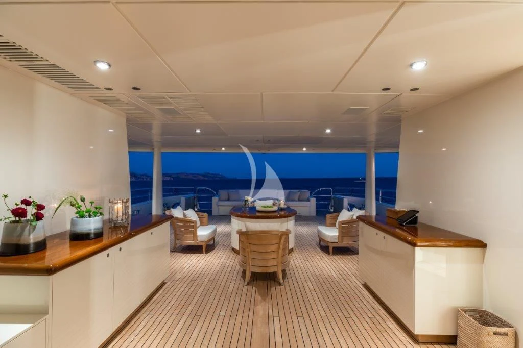a room with a table chairs and a window aboard GRACE (YET) Yacht for Sale