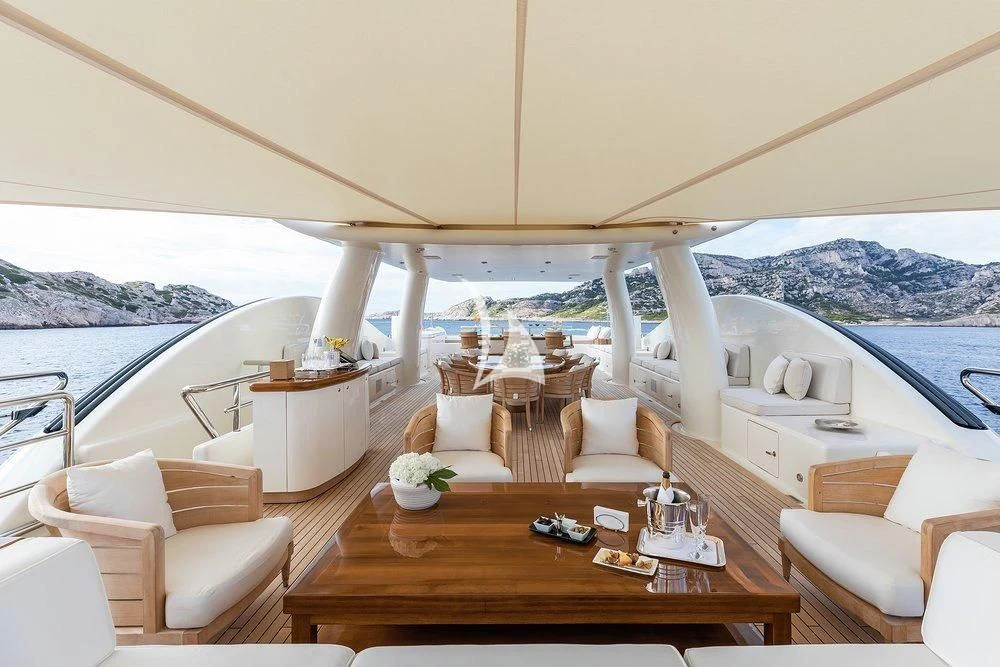 a room with a table chairs and a large body of water aboard GRACE (YET) Yacht for Sale