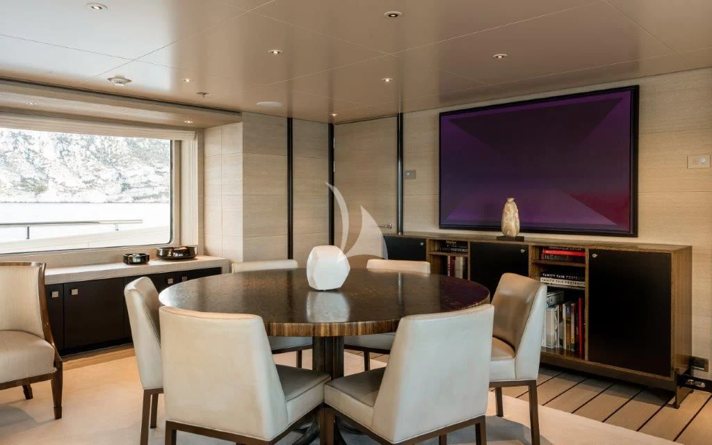a room with a tv and chairs aboard GRACE (YET) Yacht for Sale