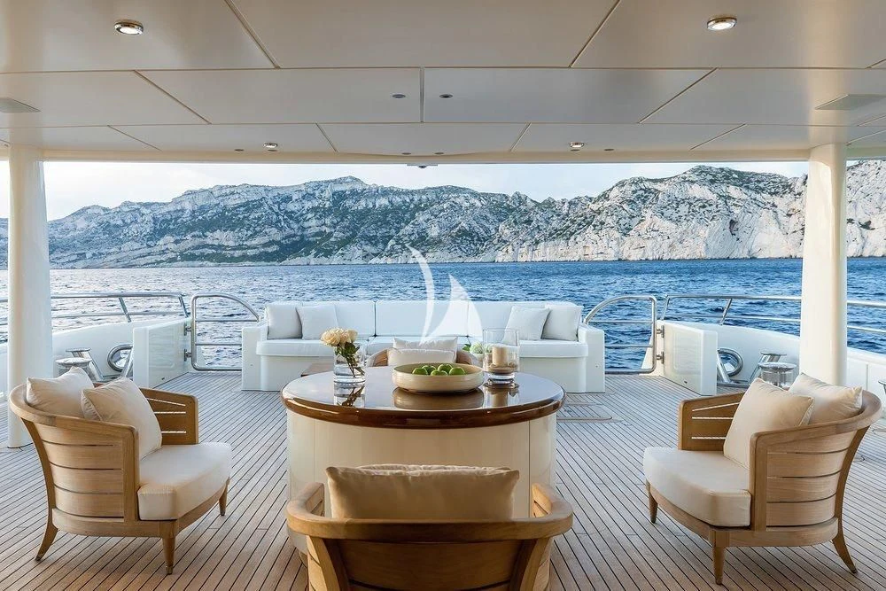a room with a table chairs and a view of mountains aboard GRACE (YET) Yacht for Sale