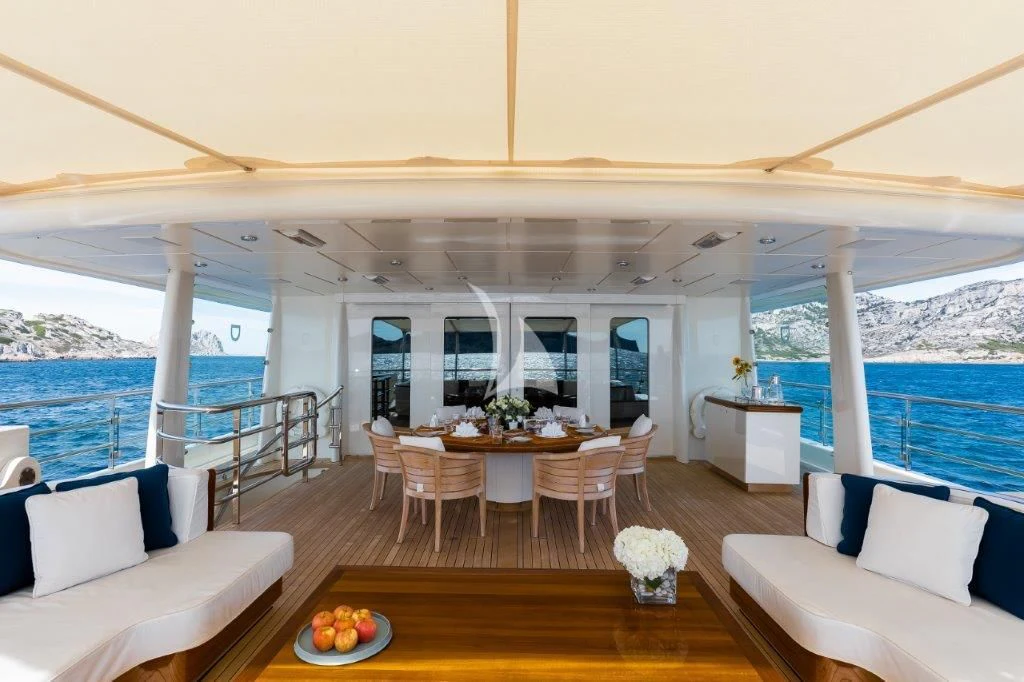a large room with a table and chairs and a large body of water aboard GRACE (YET) Yacht for Sale