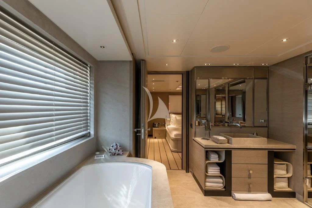 a bathroom with a tub sink and a mirror aboard GRACE (YET) Yacht for Sale