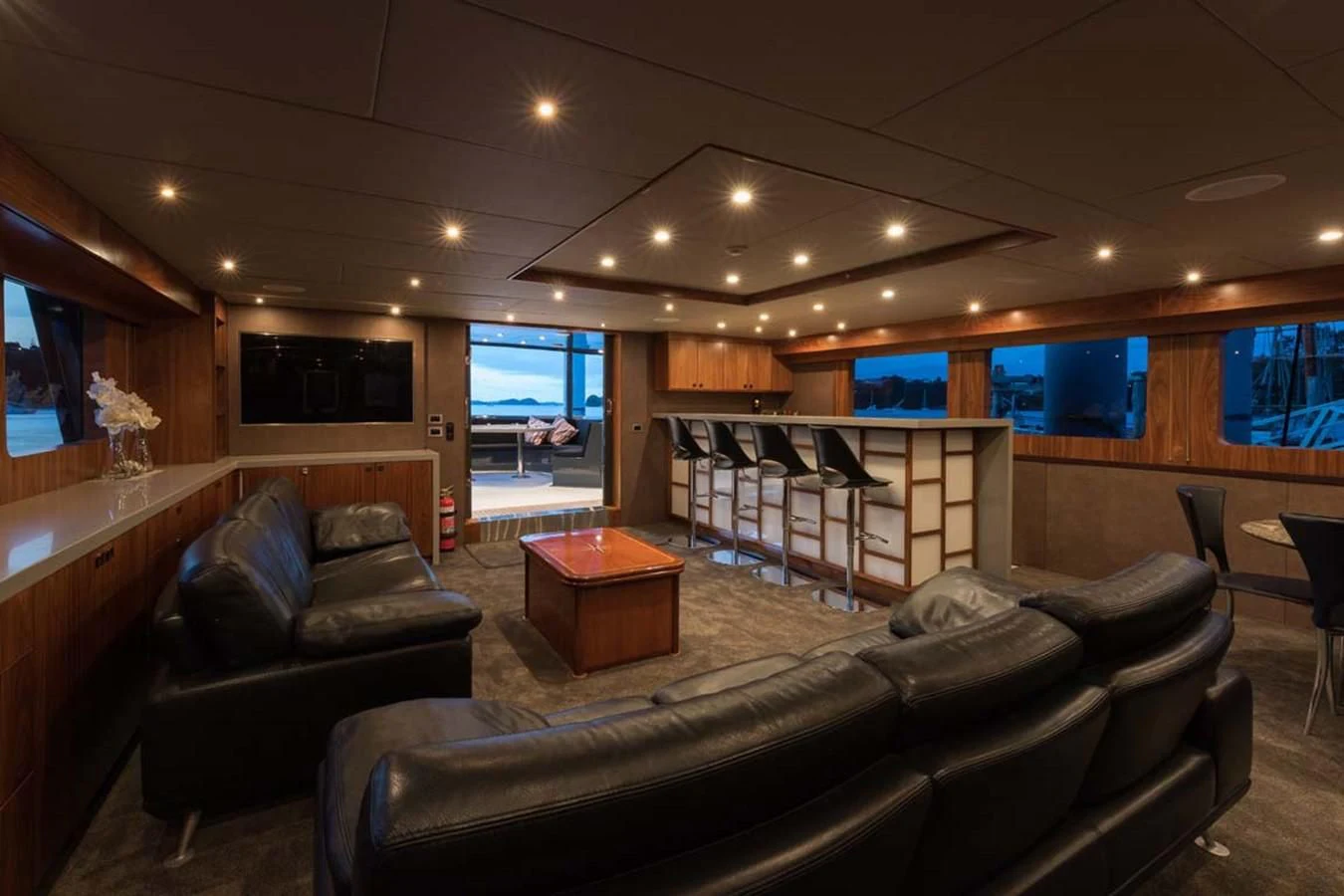 a living room with leather couches aboard PACIFIC HQ Yacht for Sale