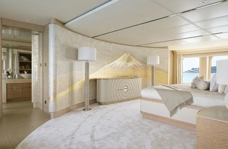 a room with a bed and a lamp aboard PLVS VLTRA Yacht for Sale