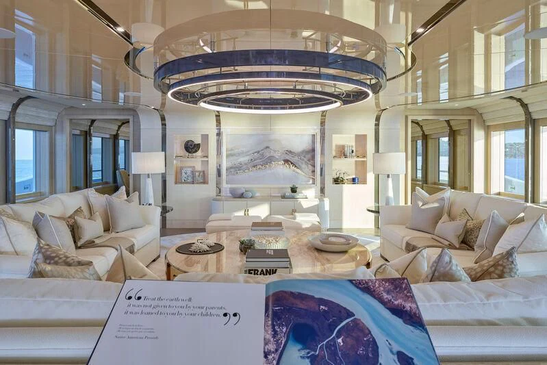 a large living room with a chandelier aboard PLVS VLTRA Yacht for Sale