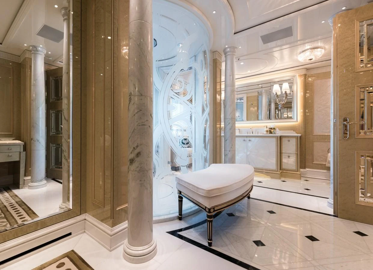 a room with a white chair and a large pillar with columns aboard PLVS VLTRA Yacht for Sale
