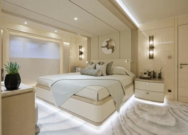 a bedroom with a large bed aboard PLVS VLTRA Yacht for Sale
