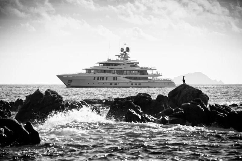 a boat on a rocky shore aboard PLVS VLTRA Yacht for Sale