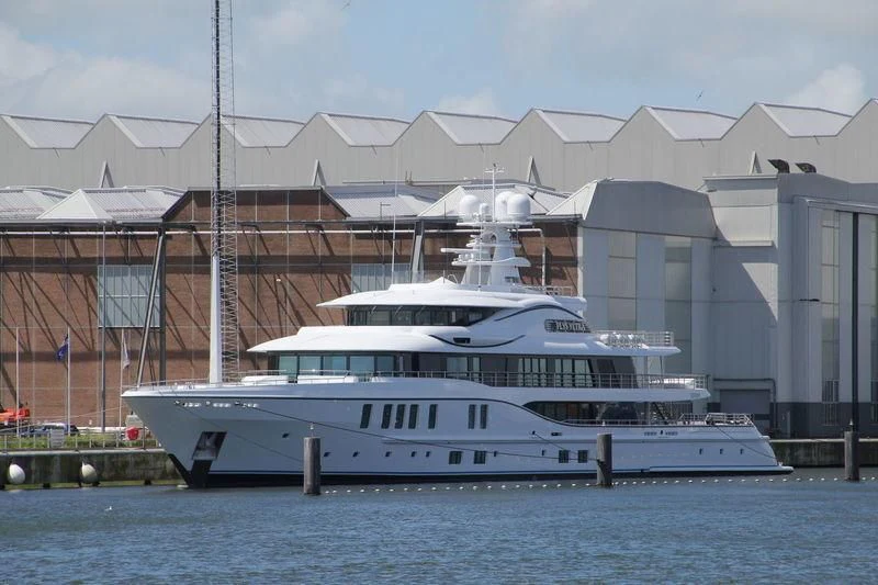 a white yacht in front of a building aboard PLVS VLTRA Yacht for Sale