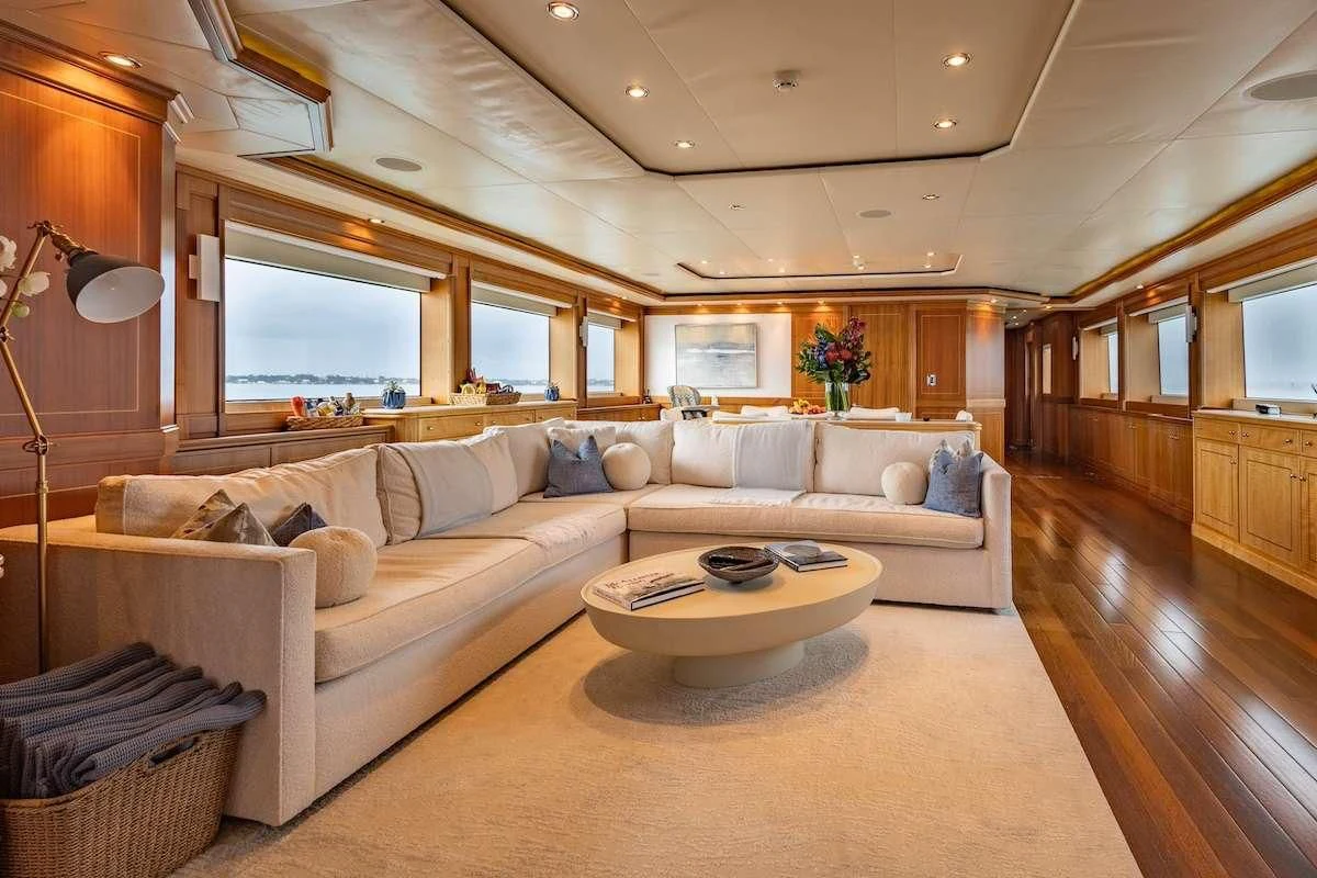 a living room with a couch and a coffee table aboard BLACK SHEEP Yacht for Sale