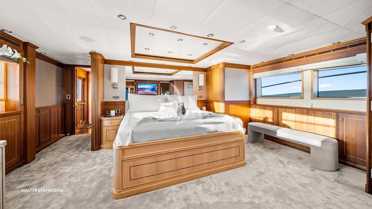 a bedroom with a bed and a desk aboard BLACK SHEEP Yacht for Sale