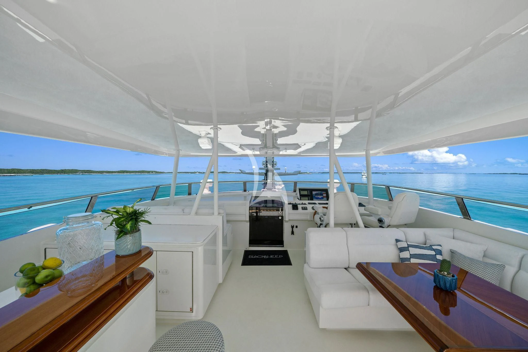 a room with a table chairs and a view of the ocean aboard BLACK SHEEP Yacht for Sale