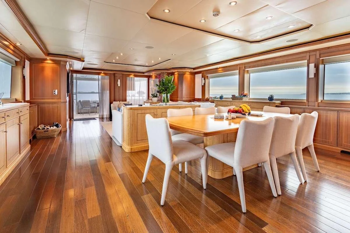 a kitchen with a table and chairs aboard BLACK SHEEP Yacht for Sale
