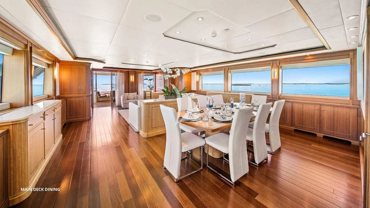 a large dining room with white chairs aboard BLACK SHEEP Yacht for Sale