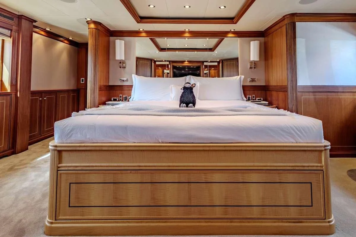 a bed with white sheets aboard BLACK SHEEP Yacht for Sale